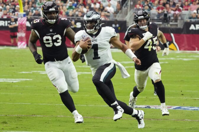 Philadelphia Eagles quarterback Jalen Hurts (1) runs for a first down against the Arizona Cardinals during the first half an NFL football game, Sunday, Oct. 9, 2022, in Glendale, Ariz.