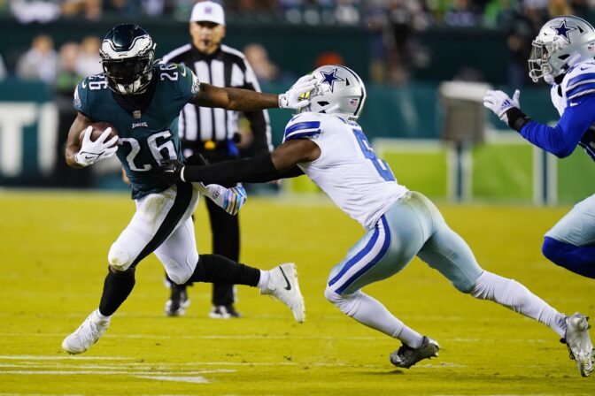 Philadelphia Eagles' Miles Sanders stiff arms Dallas Cowboys' Donovan Wilson during the first half of an NFL football game Sunday, Oct. 16, 2022, in Philadelphia.
