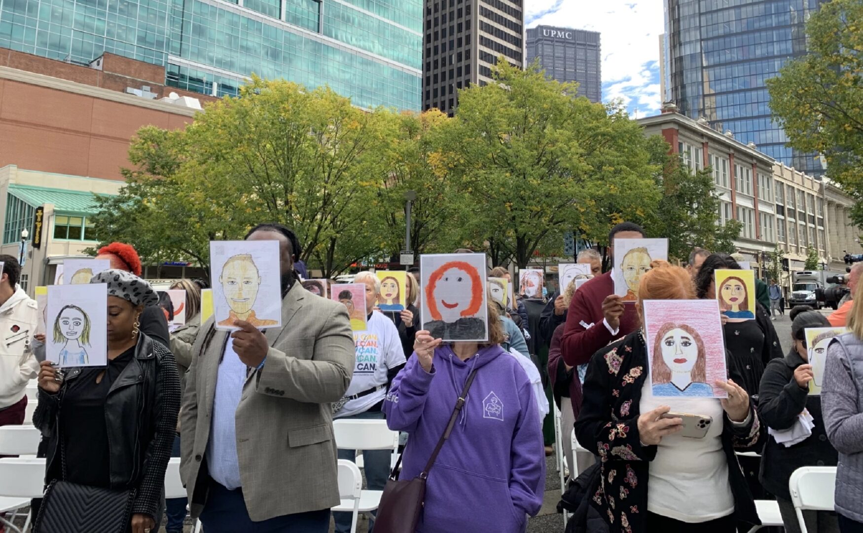 Attendees of a demonstration in Market Square on Tuesday, Oct. 4, 2022 hold self-portraits of houseless students in Allegheny County. Nearly 3,000 children and youth in the county have been identified as experiencing housing instability.
