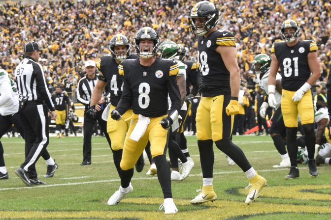 Pittsburgh Steelers quarterback Kenny Pickett (8) celebrates beside teammates after scoring a touchdown against the New York Jets during the second half of an NFL football game, Sunday, Oct. 2, 2022, in Pittsburgh.