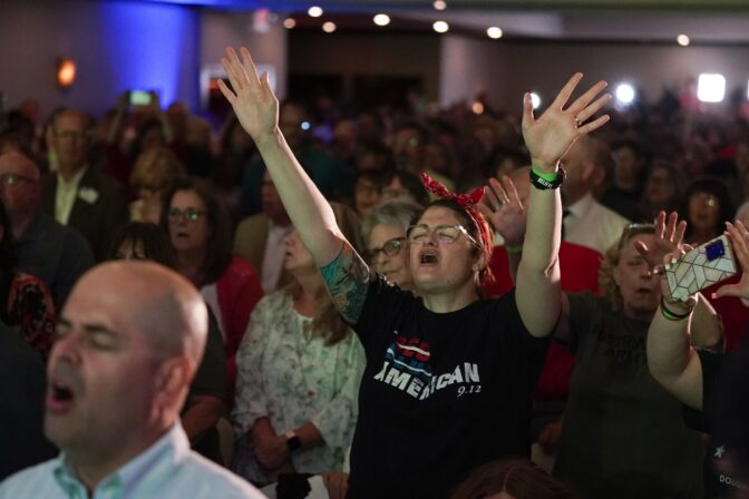 People sing before State Sen. Doug Mastriano, R-Franklin, a Republican gubernatorial candidate, speaks at a primary night election gathering in Chambersburg, Pa., Tuesday, May 17, 2022.