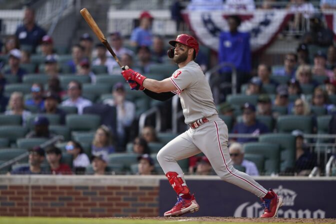 Philadelphia Phillies designated hitter Bryce Harper (3) hits a double during the sixth inning in Game 1 of a National League Division Series baseball game between the Atlanta Braves and the Philadelphia Phillies, Tuesday, Oct. 11, 2022, in Atlanta.