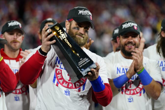 Philadelphia Phillies designated hitter Bryce Harper celebrates with the trophy after winning the baseball NL Championship Series in Game 5 against the San Diego Padres on Sunday, Oct. 23, 2022, in Philadelphia.