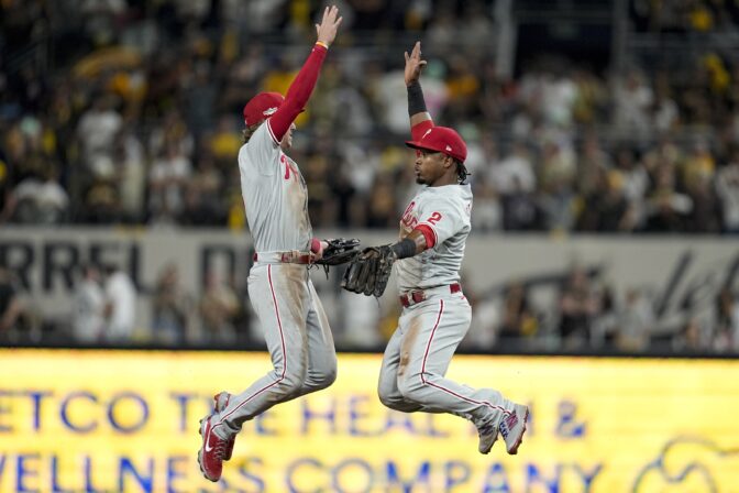 Philadelphia Phillies shortstop Bryson Stott celebrates with second baseman Jean Segura after their win against the San Diego Padres after Game 1 of the baseball NL Championship Series between the San Diego Padres and the Philadelphia Phillies on Tuesday, Oct. 18, 2022, in San Diego.