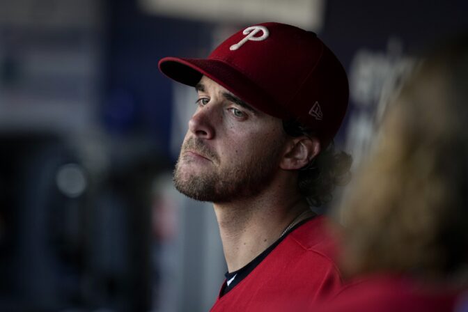 Philadelphia Phillies starting pitcher Aaron Nola sits in the dugout during the sixth inning in Game 2 of the baseball NL Championship Series between the San Diego Padres and the Philadelphia Phillies on Wednesday, Oct. 19, 2022, in San Diego.