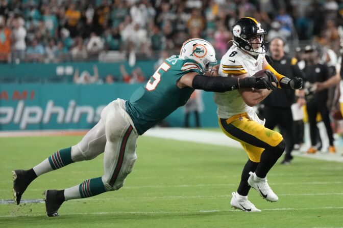 Miami Dolphins linebacker Jaelan Phillips (15) grabs Pittsburgh Steelers quarterback Kenny Pickett (8) during the second half of an NFL football game, Sunday, Oct. 23, 2022, in Miami Gardens, Fla.