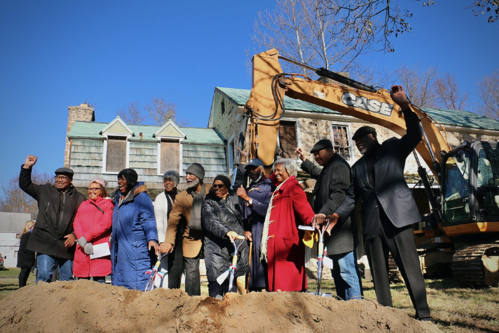 Members of the Board of the African American Museum of Bucks County celebrate at the groundbreaking for the museum at Boone Farm in Middletown Township. 