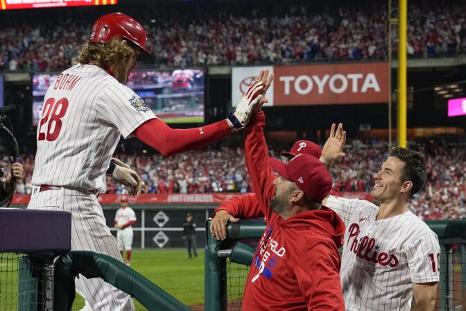 Philadelphia Phillies' Alec Bohm celebrates in the dugout after his home run during the second inning in Game 3 of baseball's World Series between the Houston Astros and the Philadelphia Phillies on Tuesday, Nov. 1, 2022, in Philadelphia.