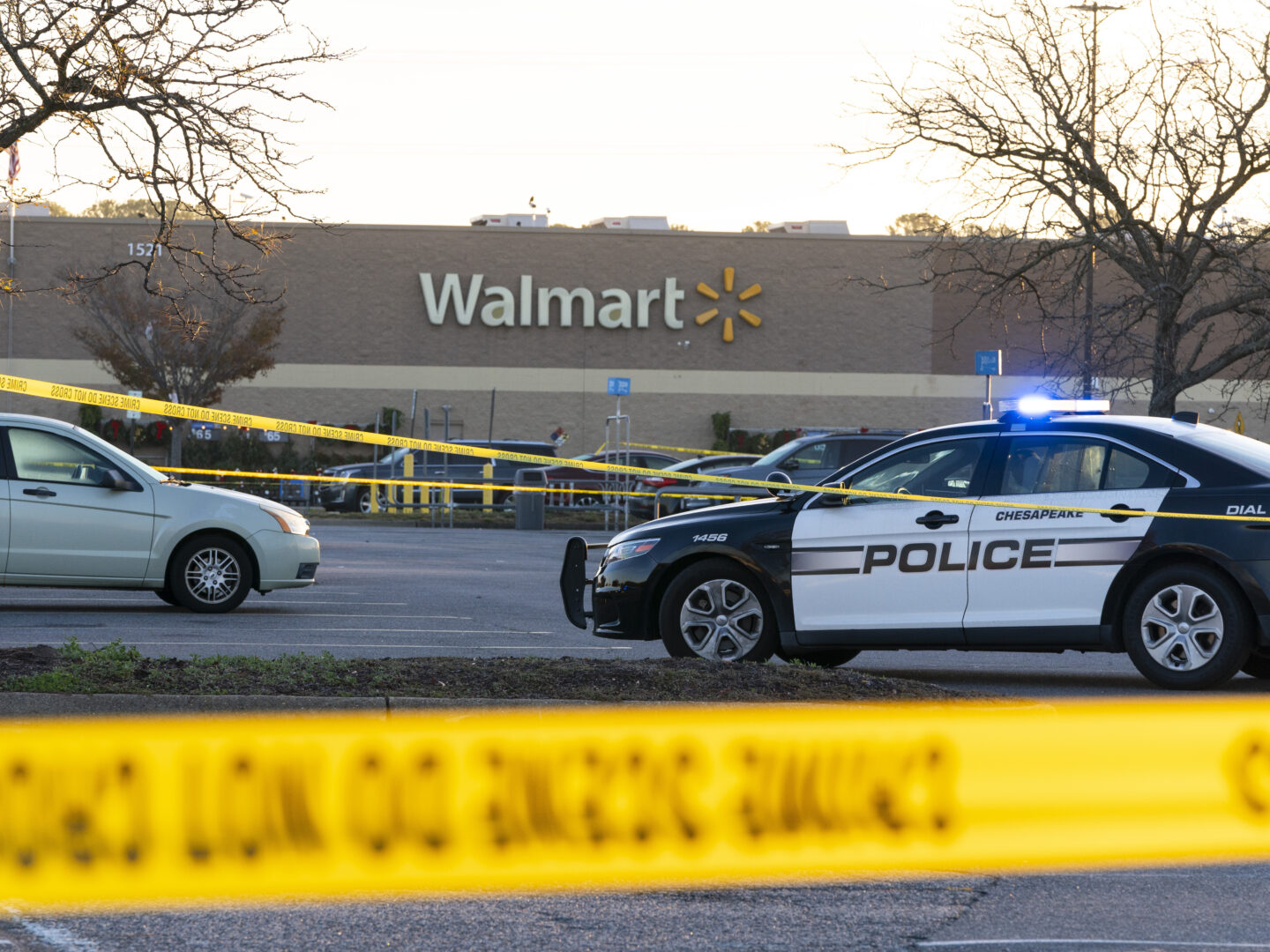 Law enforcement work the scene of a mass shooting at a Walmart, Wednesday, Nov. 23, 2022, in Chesapeake, Va.  The store was busy just before the shooting Tuesday night with people stocking up ahead of the Thanksgiving holiday.    (AP Photo/Alex Brandon)