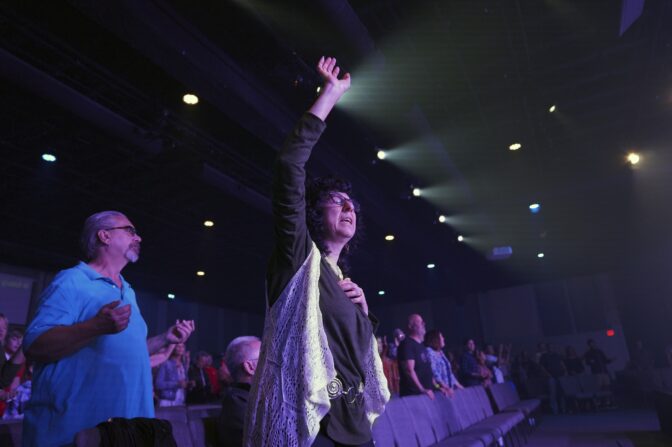Parishioner Judy Perella raises her hand in worship during service at Allison Park Church on Sunday, Nov. 6, 2022, in Allison Park, Pa.