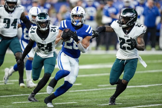 Indianapolis Colts running back Jonathan Taylor (28) runs past Philadelphia Eagles cornerback James Bradberry (24) and safety C.J. Gardner-Johnson (23) in the first half of an NFL football game in Indianapolis, Sunday, Nov. 20, 2022.