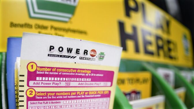 A rack with cards bettors can use to choose their own numbers to purchase lottery tickets for the Saturday Oct. 29, drawing of the Powerball lottery, are seen on a counter at a market in Prospect, Pa., Friday, Oct. 28, 2022.