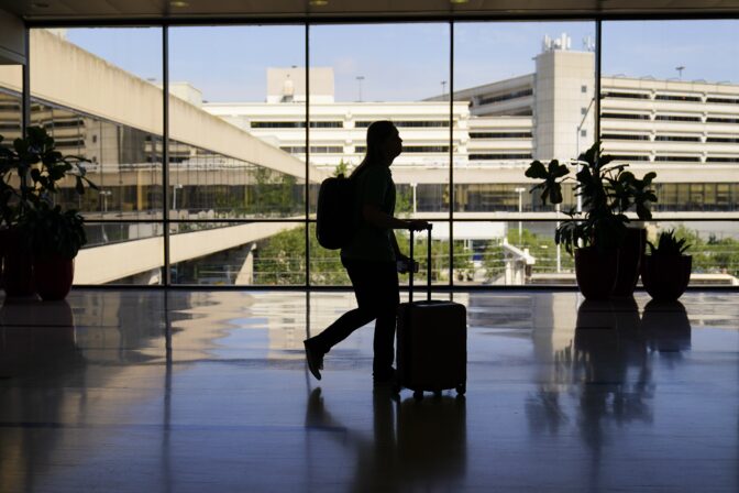 A traveler moves through the Philadelphia International Airport ahead of the Independence Day holiday weekend in Philadelphia, Friday, July 1, 2022. The concept of “going home for the holidays” changes throughout your life, and many millennials are currently going through that transition.