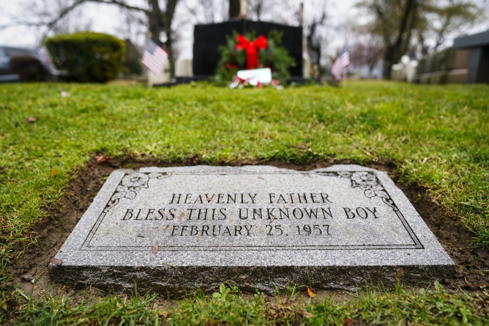 The gravesite of a small boy whose battered body body was found abandoned in a cardboard box decades ago is seen in Philadelphia, Wednesday, Dec. 7, 2022.  