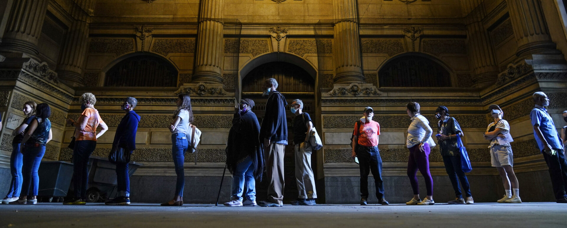 Voters wait in line to make corrections to their ballots for the midterm elections at City Hall in Philadelphia, Monday, Nov. 7, 2022. According to data from AP VoteCast, voters with no religious affiliation supported Democratic candidates and abortion rights by staggering percentages in the 2022 midterm elections. (AP Photo/Matt Rourke)