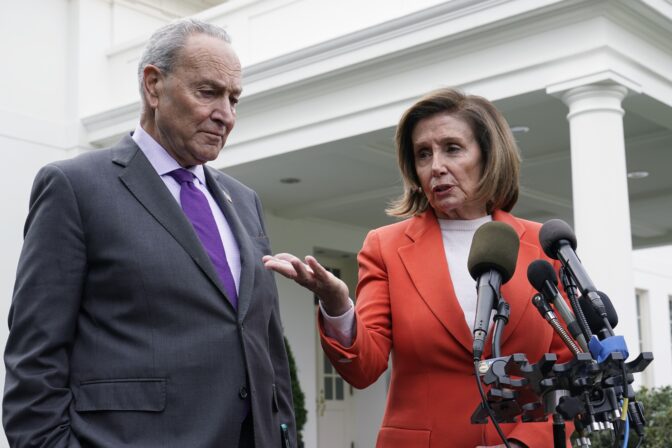 Senate Majority Leader Chuck Schumer of N.Y., right, listens as House Speaker Nancy Pelosi of Calif., left, speaks to reporters at the White House in Washington, Nov. 29, 2022, about their meeting with President Joe Biden.