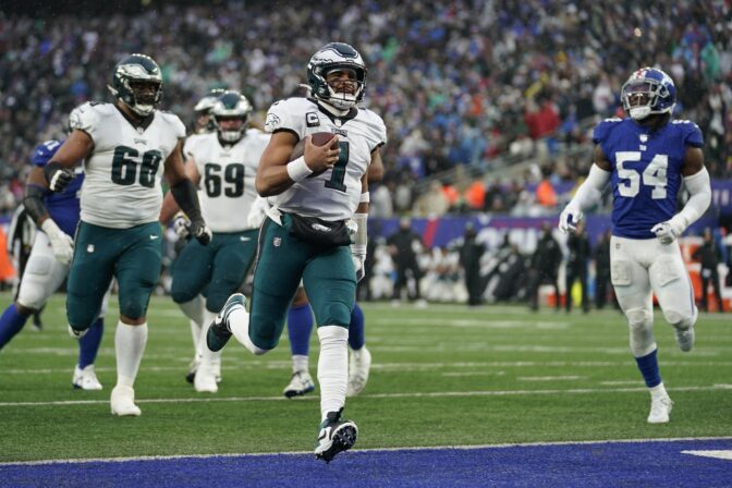 Philadelphia Eagles quarterback Jalen Hurts (1) scores a touchdown against the New York Giants during the third quarter of an NFL football game, Sunday, Dec. 11, 2022, in East Rutherford, N.J.