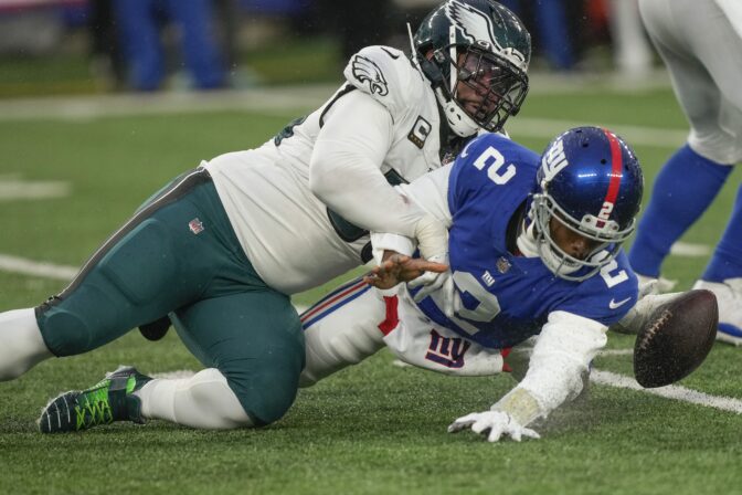 Philadelphia Eagles defensive end Brandon Graham (55) forces a fumble by New York Giants quarterback Tyrod Taylor (2) during the fourth quarter of an NFL football game, Sunday, Dec. 11, 2022, in East Rutherford, N.J.