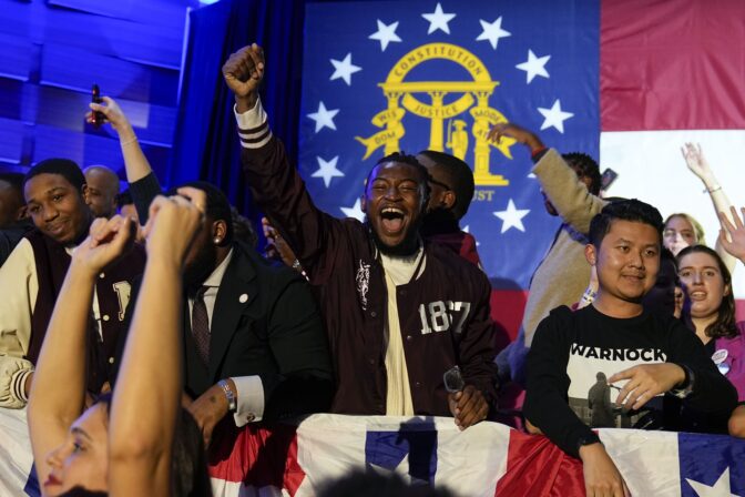 Supporters cheer during an election night watch party for Democratic Sen. Raphael Warnock, Tuesday, Dec. 6, 2022, in Atlanta. Sen. Warnock has defeated Republican challenger Herschel Walker in a runoff election in Georgia.
