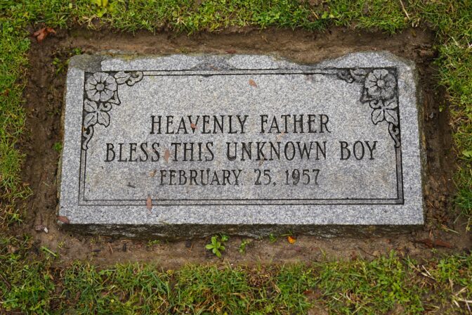 The marker of the grave of a small boy whose battered body body was found abandoned in a cardboard box decades ago in Philadelphia is seen Wednesday, Dec. 7, 2022.