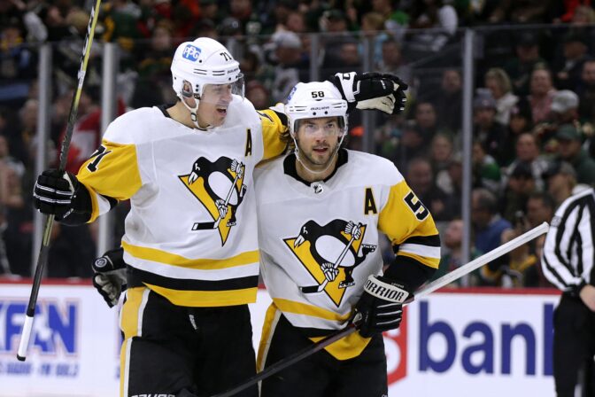 Pittsburgh Penguins defenseman Kris Letang (58) is congratulated by Evgeni Malkin (71) after scoring a goal against the Minnesota Wild during the second period of an NHL hockey game Thursday, Nov. 17, 2022, in St. Paul, Minn.