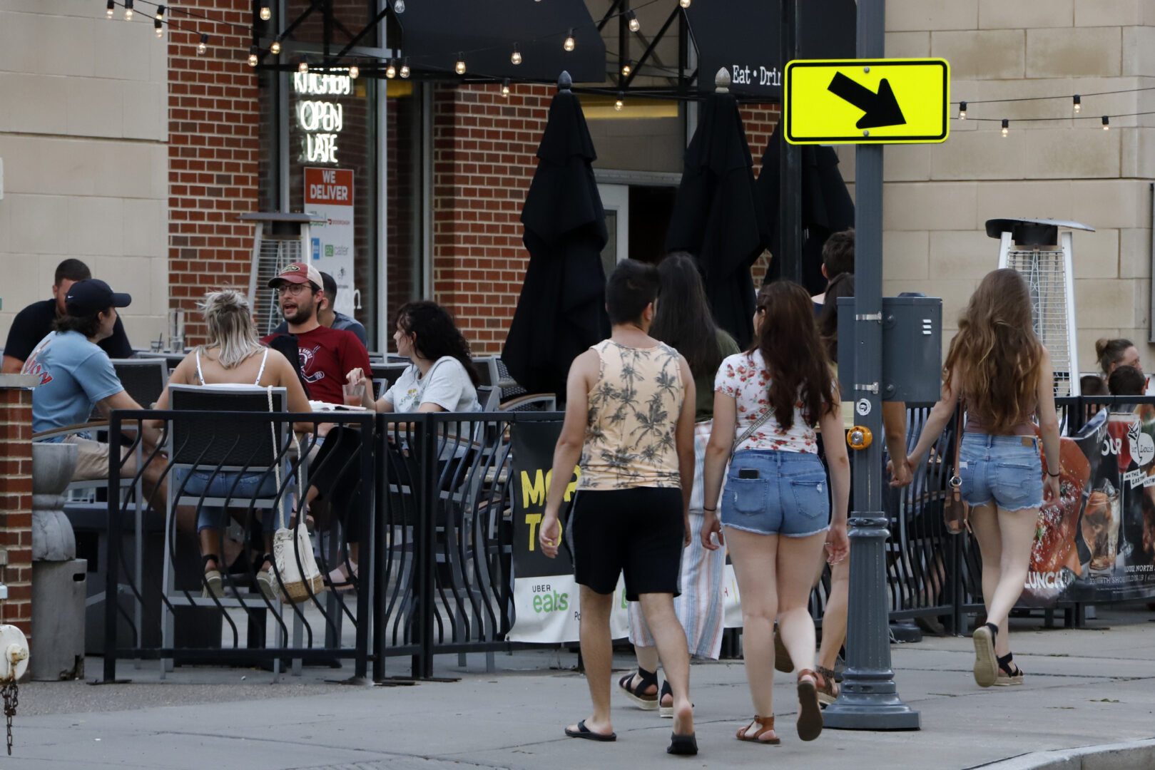 People gather at tables outside Bar Louie on the Northside of Pittsburgh Sunday, June 28, 2020. In response to the recent spike in COVID-19 cases in Allegheny County, health officials are ordering all bars and restaurants in the county to stop the sale of alcohol for on-site consumption beginning on June 30.