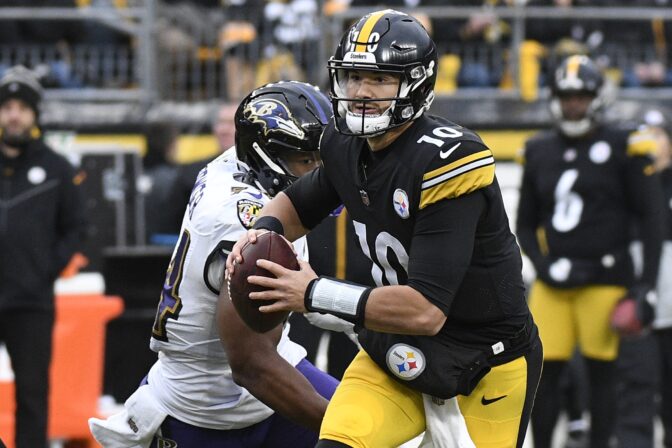 Pittsburgh Steelers quarterback Mitch Trubisky looks to pass under pressure from Baltimore Ravens linebacker Tyus Bowser during the second half of an NFL football game in Pittsburgh, Sunday, Dec. 11, 2022.