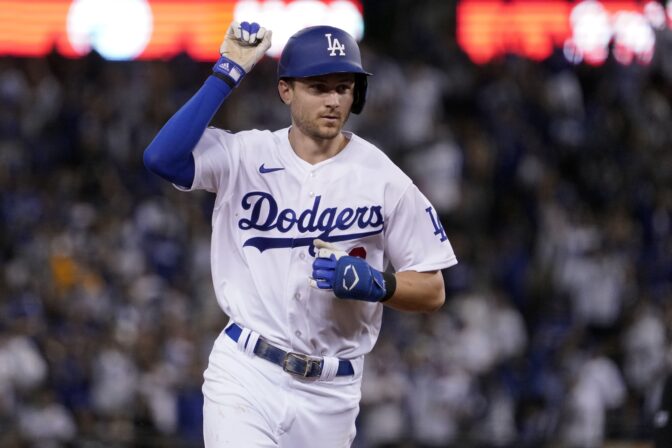 os Angeles Dodgers' Trea Turner celebrates as he runs the bases on a solo home run against the San Diego Padres during the third inning in Game 2 of a baseball NL Division Series, Wednesday, Oct. 12, 2022, in Los Angeles.