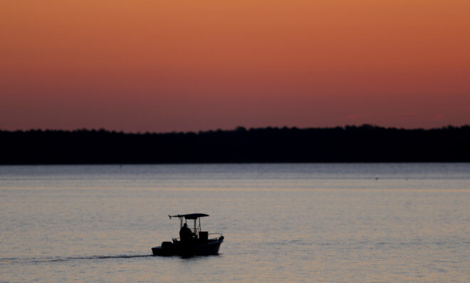 FILE - A small boat travels along the Honga River near the Chesapeake Bay, as the sky lights up at sunrise in Fishing Creek, Md., May 14, 2020. In an evaluation released on Thursday, Jan. 5, 2023, the Chesapeake Bay Foundation, an environmental group, gave the Chesapeake Bay watershed a D-plus grade, the same grade it gave the watershed in its last report in 2020.