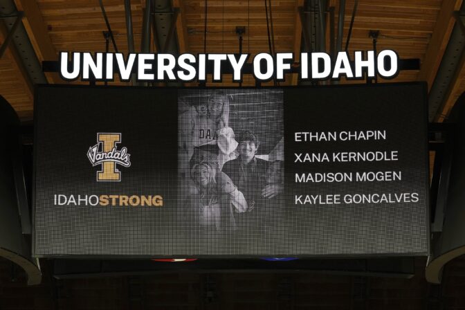 A photo and the names of four University of Idaho students who were killed over the weekend at a residence near campus are displayed during a moment of silence, Nov. 16, 2022, before an NCAA college basketball game in Moscow, Idaho.