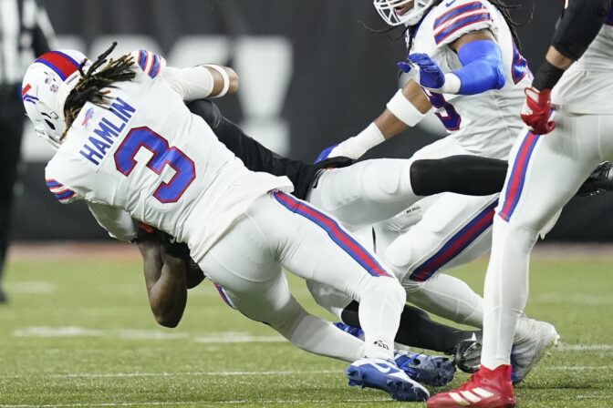 Cincinnati Bengals wide receiver Tee Higgins (85) collides with Buffalo Bills safety Damar Hamlin (3) during the first half of an NFL football game, Monday, Jan. 2, 2023, in Cincinnati.