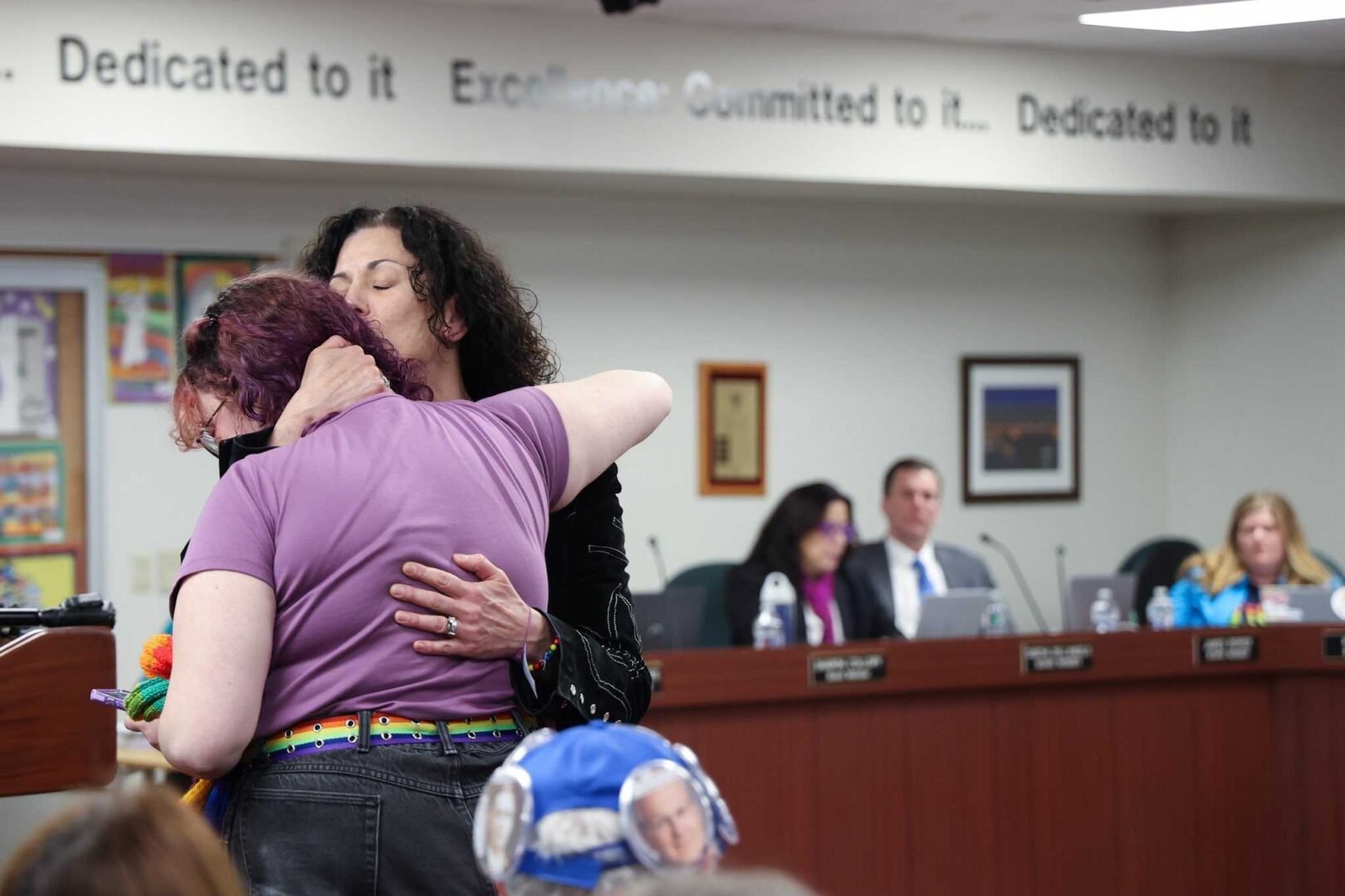 Kathleen Weintraub hugged their child, CJ, before they spoke at the Central Bucks School District board meeting on Jan. 10, 2023. 