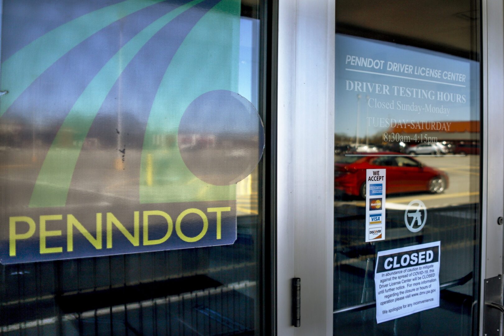 Closed signs are on the doors of the Penndot Drivers License Center in Butler, Pa., Friday, April 3, 2020.  
