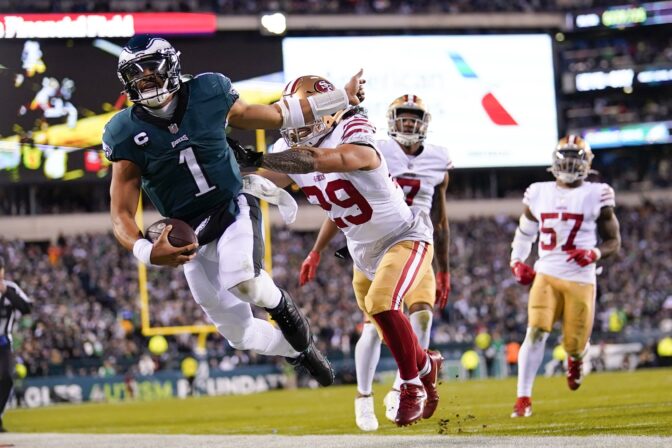 Philadelphia Eagles quarterback Jalen Hurts (1) is pushed out of bounds by San Francisco 49ers safety Talanoa Hufanga (29) during the second half of the NFC Championship NFL football game between the Philadelphia Eagles and the San Francisco 49ers on Sunday, Jan. 29, 2023, in Philadelphia.