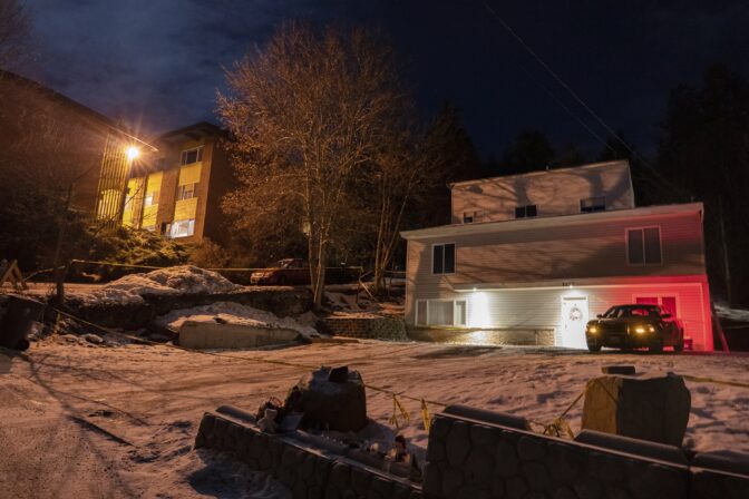 A private security officer sits in a vehicle, Tuesday, Jan. 3, 2023, in front of the house in Moscow, Idaho where four University of Idaho students were killed in November, 2022.