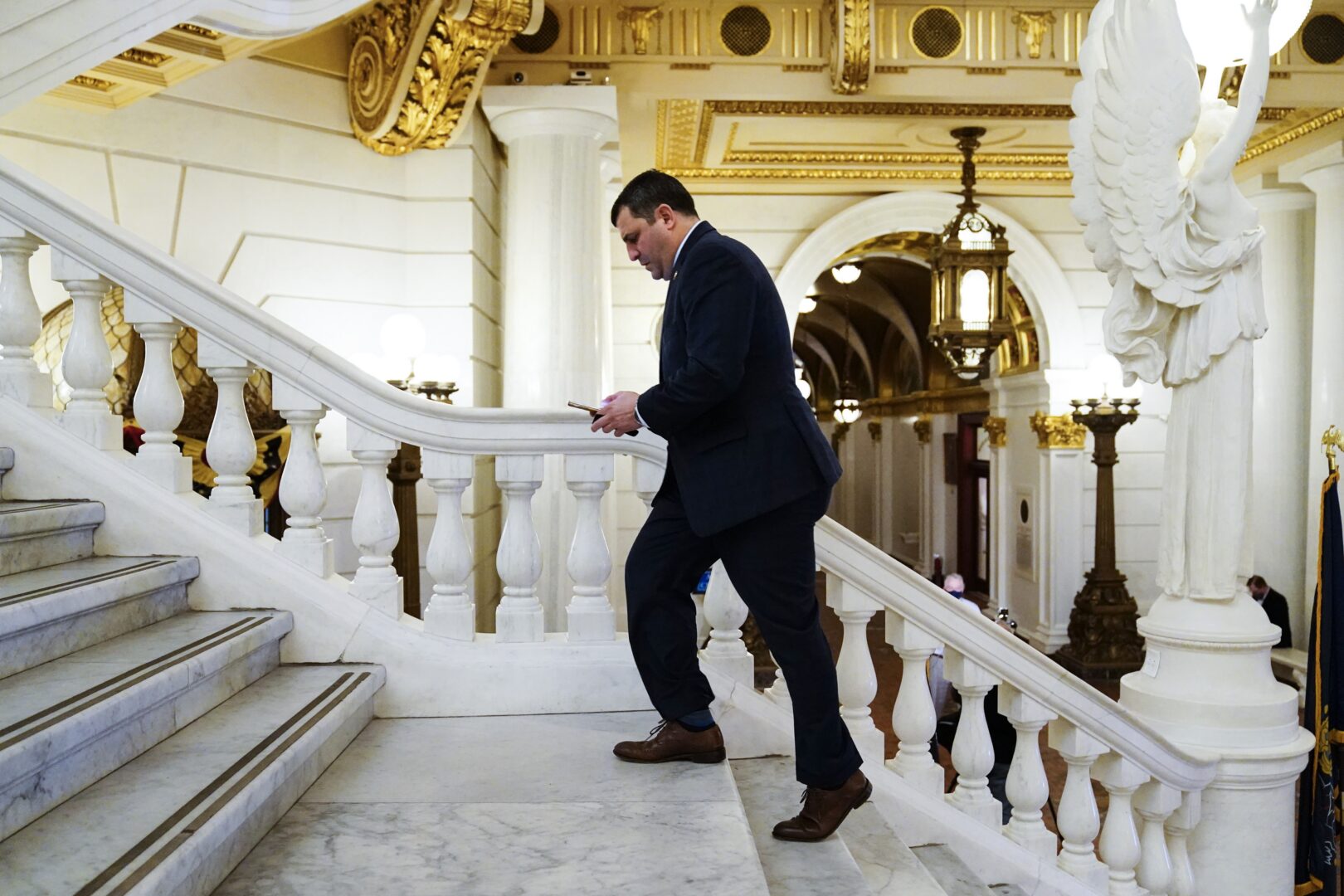 Rep. Mark Rozzi, D-Berks, checks his phone after speaking with members of the media at the Capitol in Harrisburg, Pa., Monday, March 22, 2021.  