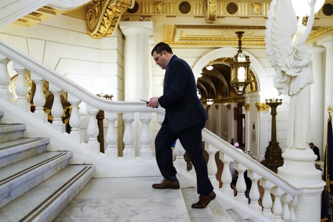 Rep. Mark Rozzi, D-Berks, checks his phone after speaking with members of the media at the Capitol in Harrisburg, Pa., Monday, March 22, 2021.