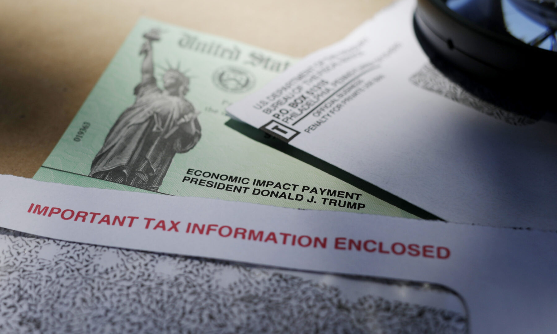 FILE - President Donald Trump's name is seen on a stimulus check issued by the IRS to help combat the adverse economic effects of the COVID-19 outbreak, on April 23, 2020, in San Antonio. The IRS announced Friday. Feb. 10, 2023, that most relief checks issued by states last year aren’t subject to federal taxes, providing 11th hour guidance as tax returns start to pour in. (AP Photo/Eric Gay, File)