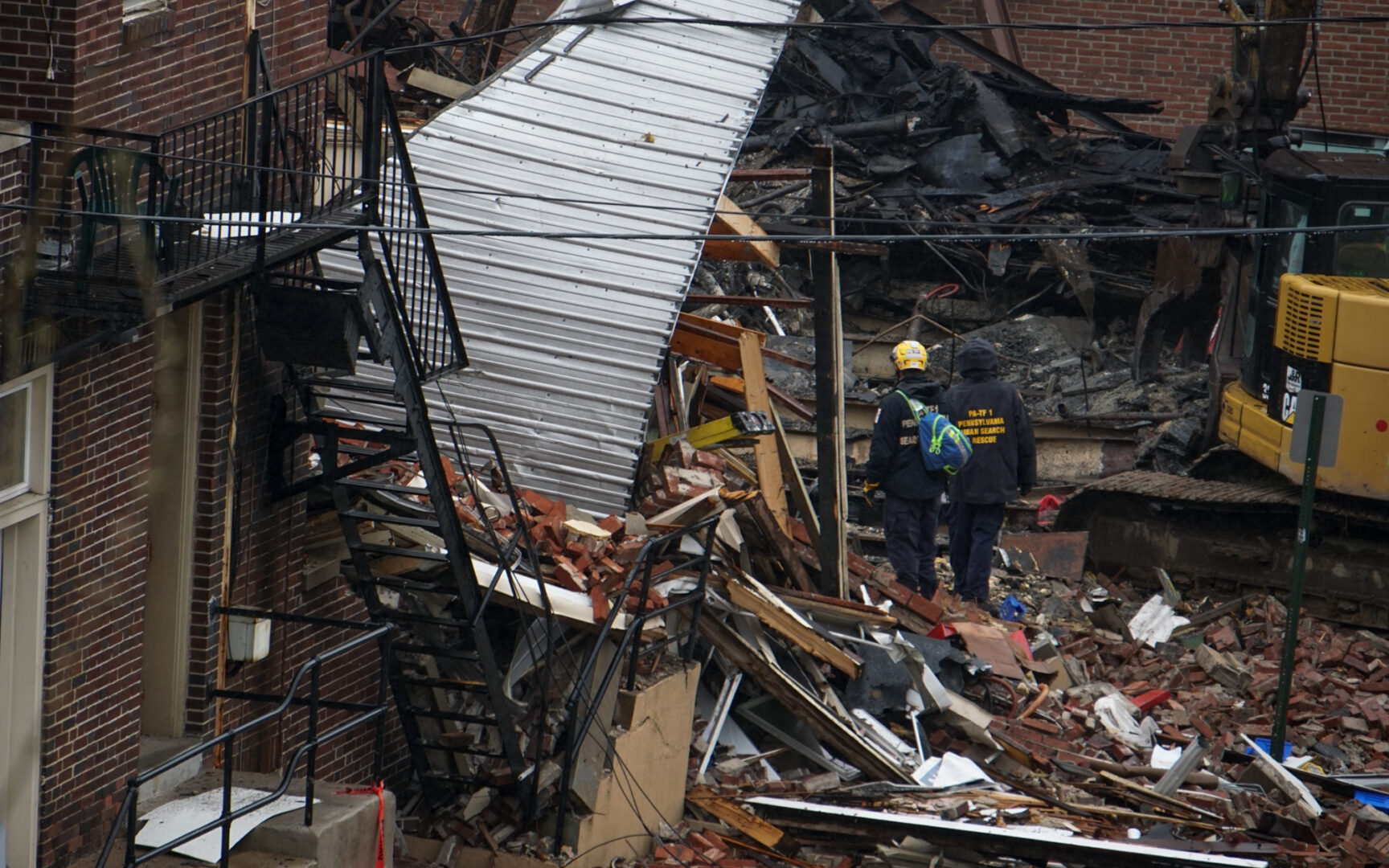Emergency crews sift through the rubble on March 25, for several missing people after an explosion  at R.M. Palmer Co. on March 24, 2023 after an explosion destroyed part of the candy factory. (Jeremy Long - WITF)
