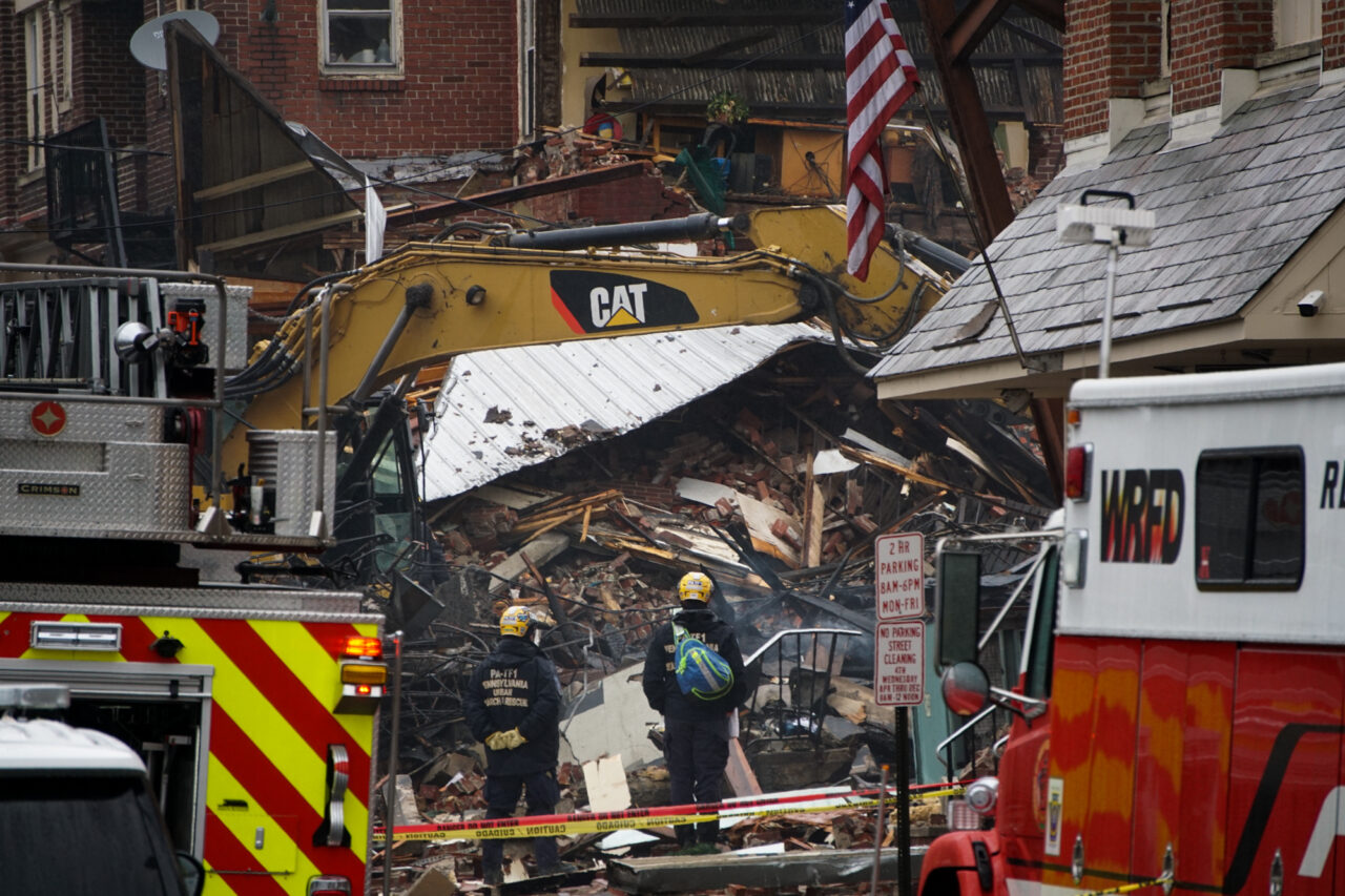 Emergency crews sift through the rubble on March 25, for several missing people after an explosion at R.M. Palmer Co. on March 24, 2023 after an explosion destroyed part of the candy factory.