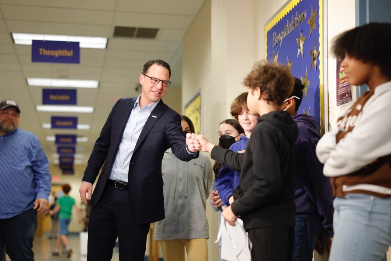 Gov. Josh Shapiro fist bumps a Colfax K-8 student on Tuesday during a school visit to discuss the state's teacher shortage.
