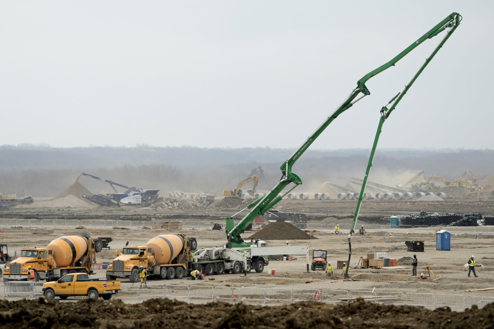 Workers prepare the site of a $4 billion Panasonic EV battery plant Thursday, March 30, 2023, near DeSoto, Kan. Economic incentives offered by Kansas state and local governments beat out those offered by neighboring Oklahoma to help lure the project to the site on land formerly occupied by an Army ammunition plant. (AP Photo/Charlie Riedel)