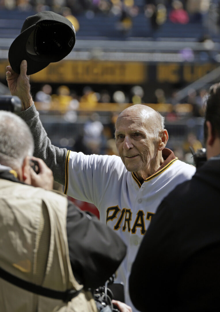 FILE - Former Pittsburgh Pirates shortstop Dick Groat, center, acknowledges fans at PNC Park during a pregame ceremony honoring his lifetime of service to the Pirates organization, before a baseball game against the St. Louis Cardinals in Pittsburgh, Monday, April 1, 2019. Groat, a two-sport star who went from All-American guard in basketball to a brief stint in the NBA to ultimately an All-Star shortstop and the 1960 National League MVP while playing baseball for his hometown Pittsburgh Pirates, has died. He was 92. Groat's family said in a statement that Groat died early Thursday morning, April 27, 2023, at UMPC Presbyterian Hospital due to complications from a stroke. 