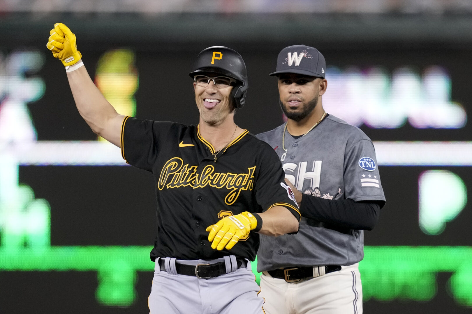 Pittsburgh Pirates' Drew Maggi reacts in front of Washington Nationals second baseman Luis Garcia after hitting a double in the ninth inning of the second baseball game of a doubleheader, Saturday, April 29, 2023, in Washington. (AP Photo/Patrick Semansky)