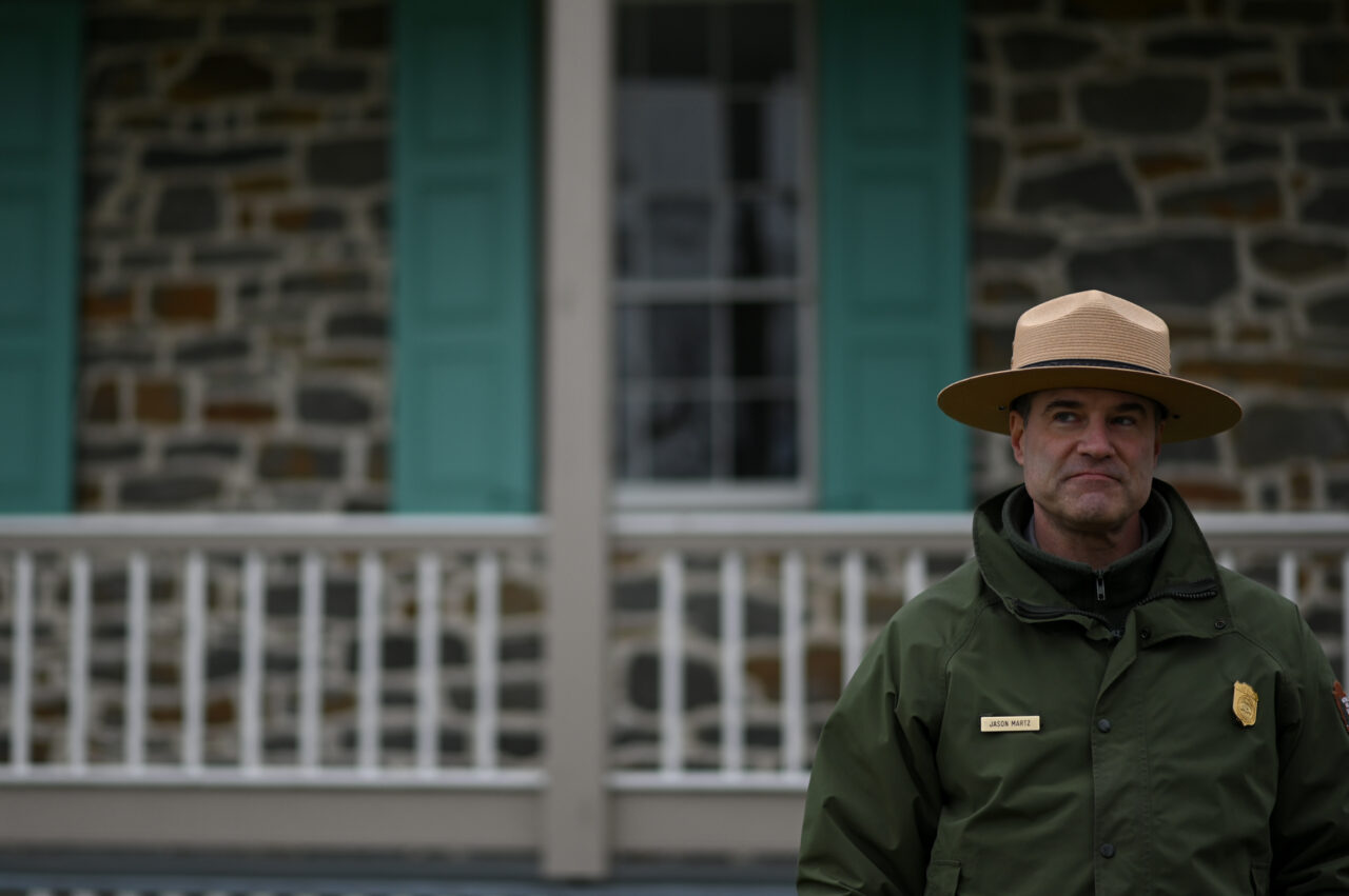 National Parks Communications Spcialist Jason Martz talks about the benefits of the National Parks leasing program in front of the Rose House