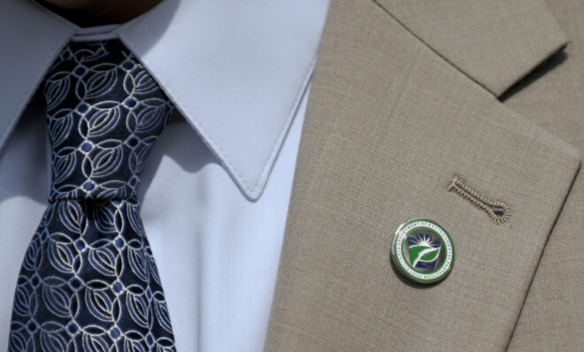 Pennsylvania Department of Environmental Protection Acting Secretary Rich Negrin's lapel pin seen at a news conference where it was announced the Shapiro Administration's commitment to fight climate change under a new EPA climate grant program at Soldier's &amp; Sailor's Grove in Harrisburg on April 14, 2023 (Jeremy Long - WITF)