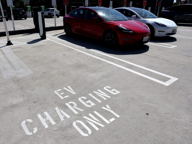 Tesla cars recharge at a Tesla Supercharger station 