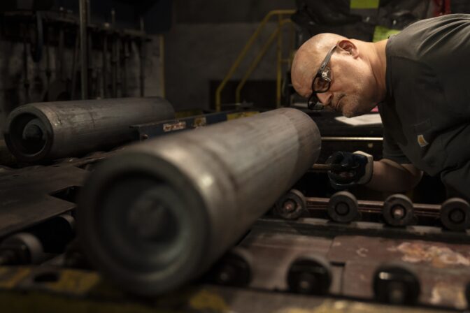 A steel worker inspects a 155 mm M795 artillery projectile during the manufacturing process at the Scranton Army Ammunition Plant in Scranton, Pa., Thursday, April 13, 2023.