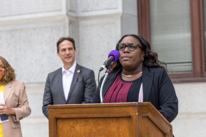 Philadelphia council member Kendra Brooks spoke at press conference calling for more legislation to limit federal pollution from Pennsylvania’s top 20 polluting corporations outside City Hall on May 9, 2023. (Kimberly Paynter/WHYY)