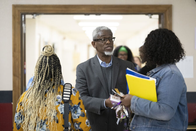 William Penn School District Superintendent Eric Becoats, center, speaks with prospective applicants during a teachers job fair at the high school's cafeteria in Lansdowne, Pa., Wednesday, May 3, 2023